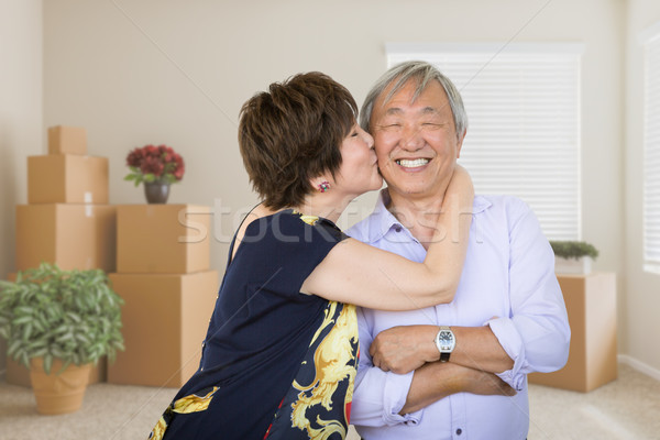 Happy Senior Chinese Couple Inside Empty Room with Moving Boxes  Stock photo © feverpitch