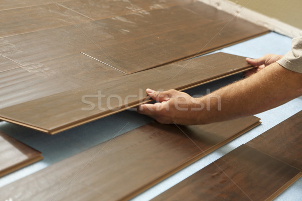 Man Installing New Laminate Wood Flooring Stock photo © feverpitch