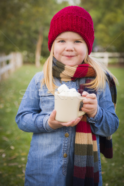 Cute Young Girl Holding Cocoa Mug with Marsh Mallows Outside Stock photo © feverpitch