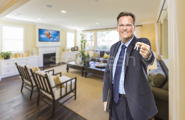 Stock photo: Male Real Estate Agent Holding Keys in Beautiful Living Room