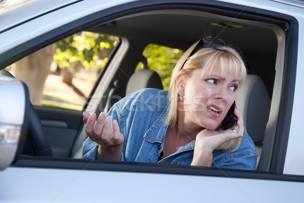 Concerned Woman Using Cell Phone While Driving Stock photo © feverpitch