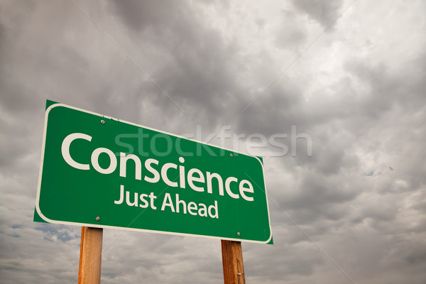 Stock photo: Conscience Green Road Sign Over Storm Clouds