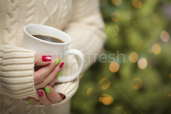 Stock photo: Woman with Red and Green Nail Polish Holding Cup of Coffee