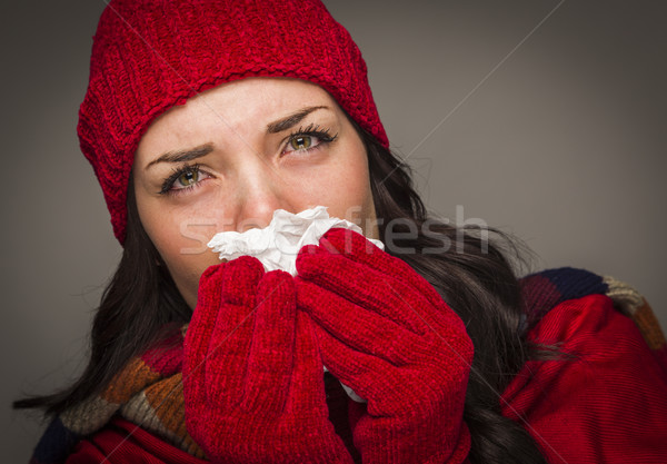 Sick Mixed Race Woman Blowing Her Sore Nose With Tissue Stock photo © feverpitch
