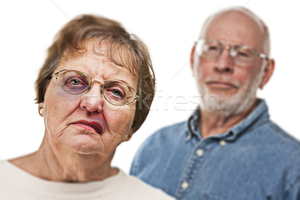 Battered and Scared Woman with Ominous Man Behind Stock photo © feverpitch