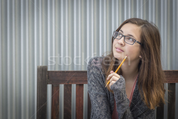 Young Daydreaming Female Student With Pencil Looking to the Side Stock photo © feverpitch