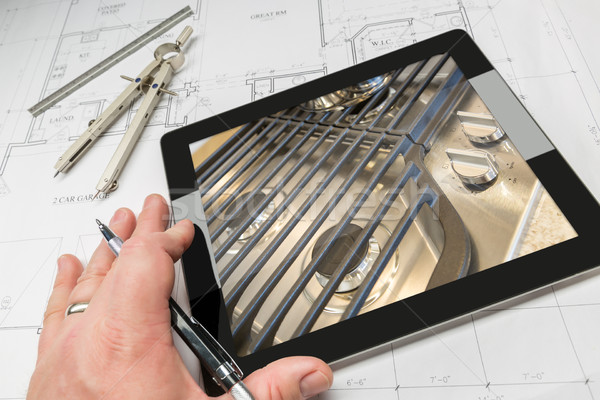 Hand of Architect on Computer Tablet Showing Stove Details Over  Stock photo © feverpitch