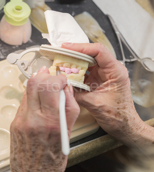 Dental Technician Applying Porcelain To 3D Printed Implant Mold Stock photo © feverpitch