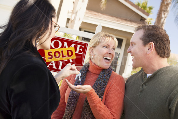 Hispanic Female Real Estate Agent Handing Keys to Excited Couple Stock photo © feverpitch