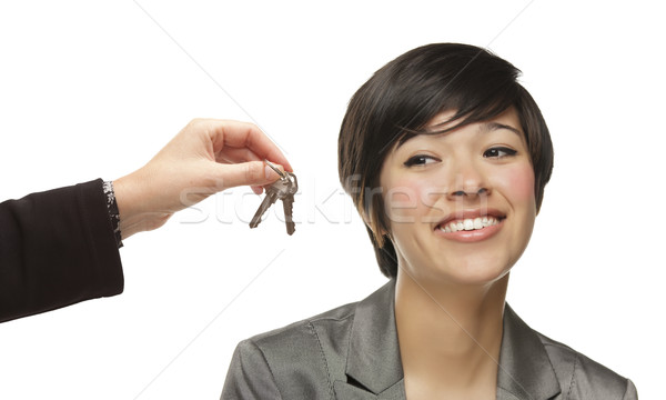 Mixed Race Young Woman Being Handed Keys on White Stock photo © feverpitch