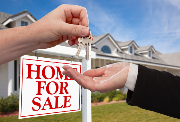 Handing Over the House Keys in Front of New Home Stock photo © feverpitch