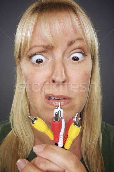 Confused Woman Holding Electronic Cables Stock photo © feverpitch