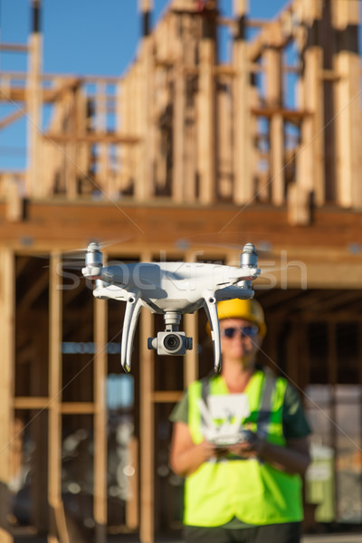 Female Pilot Flies Drone Quadcopter Inspecting Construction Site Stock photo © feverpitch
