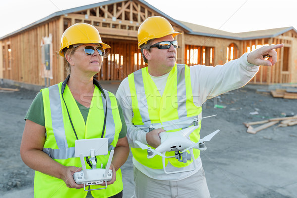 Workers with Drone Quadcopter Inspecting Photographs on Controll Stock photo © feverpitch