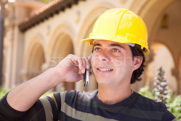 Handsome Hispanic Contractor on Phone with Hard Hat Outside Stock photo © feverpitch