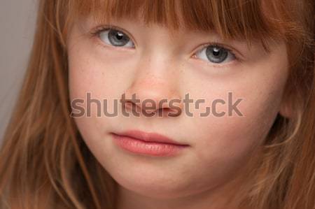 Fun Portrait of an Adorable Red Haired Girl on Grey Stock photo © feverpitch