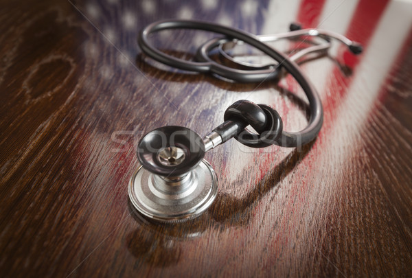 Knotted Stethoscope with American Flag Reflection on Table Stock photo © feverpitch