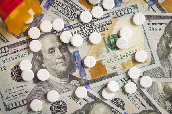 Medicine Pills Scattered on Newly Designed One Hundred Dollar Bi Stock photo © feverpitch