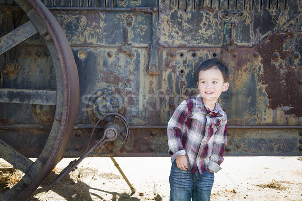 Cute Young Mixed Race Boy Having Fun Near Antique Machinery Stock photo © feverpitch