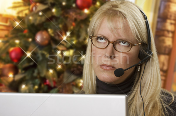 Upset Woman with Headset In Front of Christmas Tree and Computer Stock photo © feverpitch