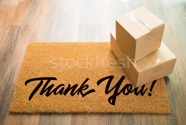 Thank You Welcome Mat On Wood Floor With Shipment of Boxes Stock photo © feverpitch