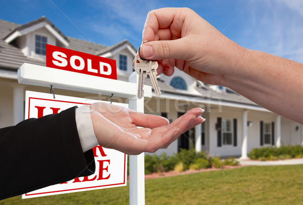 Handing Over the House Keys in Front of Sold New Home Stock photo © feverpitch