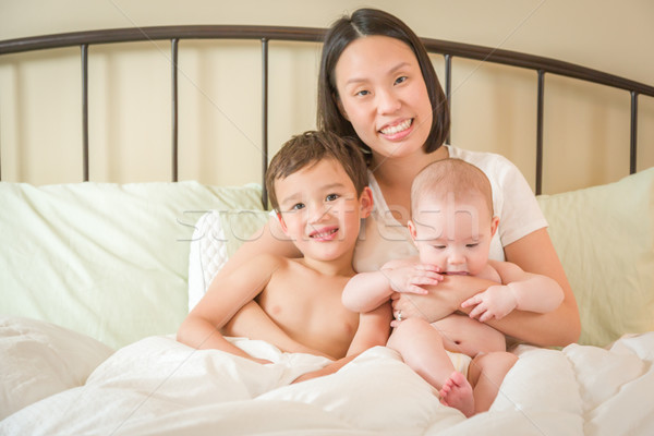 Mixed Race Chinese and Caucasian Baby Boys Laying In Bed with Th Stock photo © feverpitch