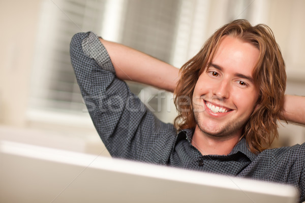 Happy Young Man Using Laptop Computer Stock photo © feverpitch