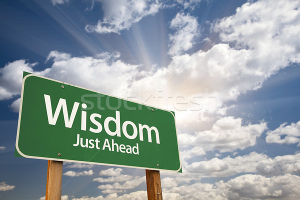 Wisdom Green Road Sign Over Clouds Stock photo © feverpitch