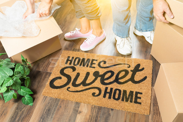 Man and Woman Unpacking Near Home Sweet Home Welcome Mat, Moving Stock photo © feverpitch