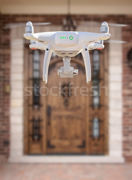 Back of Unmanned Aircraft System (UAV) Quadcopter Drone Flying A Stock photo © feverpitch