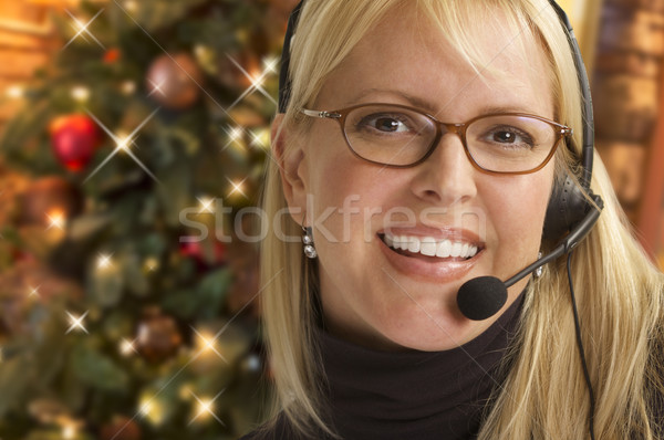 Woman with Phone Headset In Front of Christmas Tree Stock photo © feverpitch