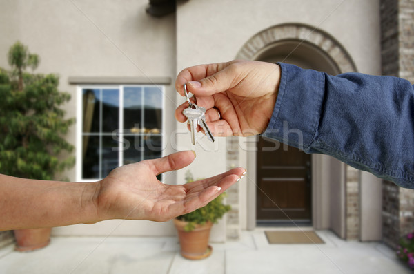Handing Over the House Keys in Front of New Home Stock photo © feverpitch