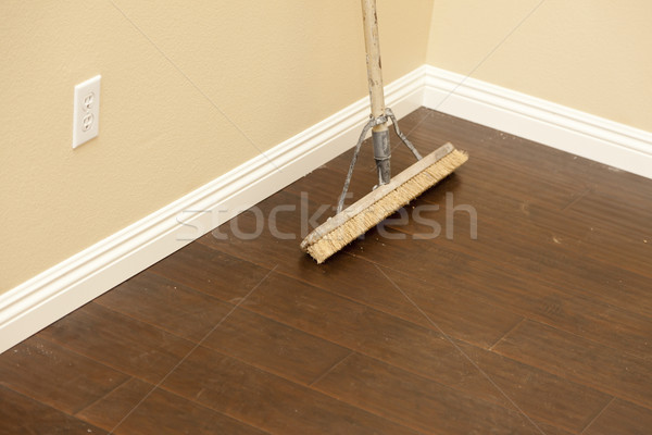 Push Broom on a Newly Installed Laminate Floor and Baseboard Stock photo © feverpitch