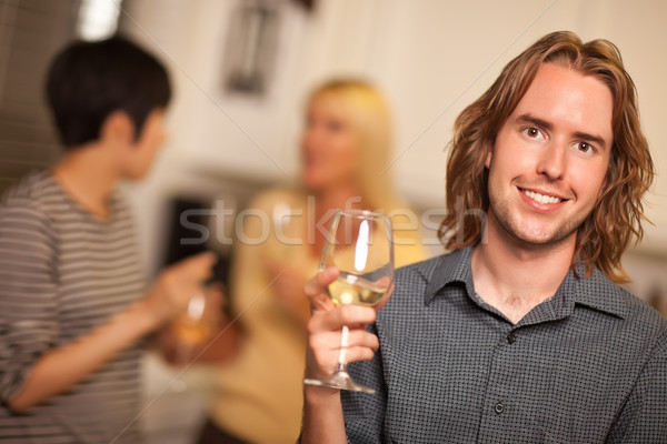 Smiling Young Man with Glass of Wine Socializing Stock photo © feverpitch