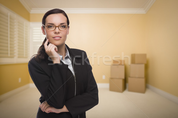 Mixed Race Woman in Empty Room with Boxes Stock photo © feverpitch