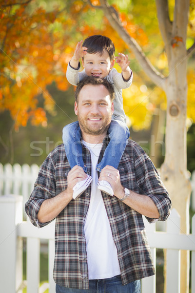 Mixed Race Boy Riding Piggyback on Shoulders of Caucasian Father Stock photo © feverpitch