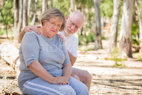 Upset Senior Woman Sits With Concerned Husband Outdoors Stock photo © feverpitch