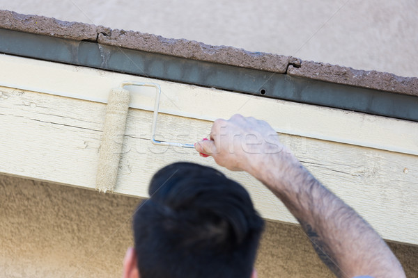 Professional Painter Using Small Roller to Paint House Fascia Stock photo © feverpitch