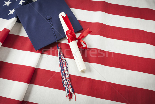 Graduation Cap and Diploma Resting on American Flag Stock photo © feverpitch
