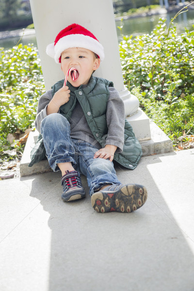 Cute Mixed Race Boy With Santa Hat and Candy Cane Stock photo © feverpitch