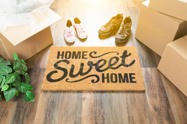 Home Sweet Home Welcome Mat, Moving Boxes, Women and Male Shoes  Stock photo © feverpitch