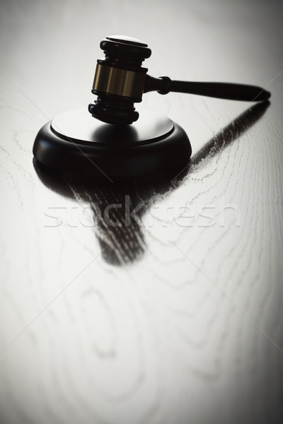 Dramatic Gavel Silhouette on Reflective Wood Stock photo © feverpitch
