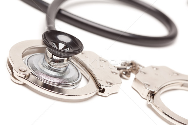 Stethoscope and Handcuffs on White Stock photo © feverpitch