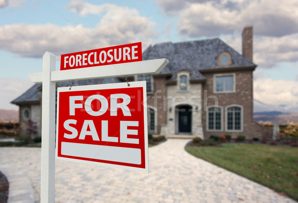 Stock photo: Foreclosure Home For Sale Sign and House