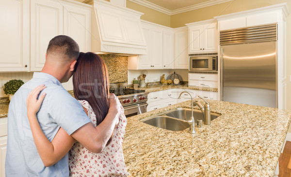 Young Hopeful Military Couple Looking At Custom Kitchen Stock photo © feverpitch