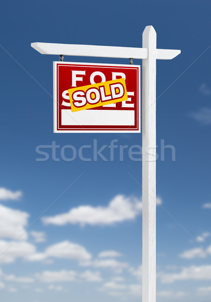 Stock photo: Left Facing Sold For Sale Real Estate Sign on a Blue Sky with Cl