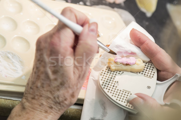 Dental Technician Applying Porcelain To 3D Printed Implant Mold Stock photo © feverpitch
