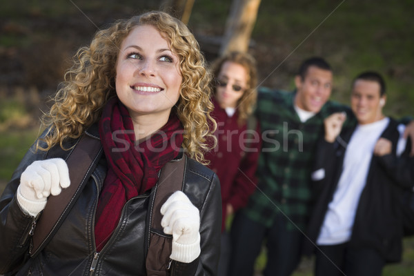 Pretty Young Teen Girl with Boys Behind Admiring Her Stock photo © feverpitch