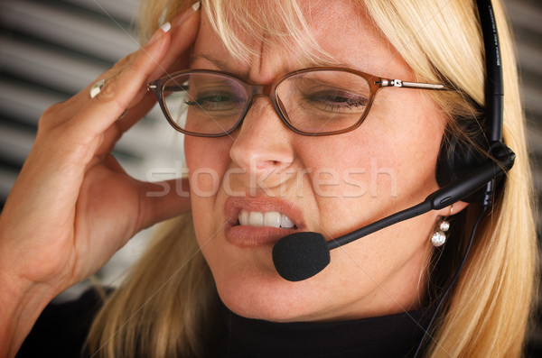 Businesswoman with Phone Headset and Headache Stock photo © feverpitch